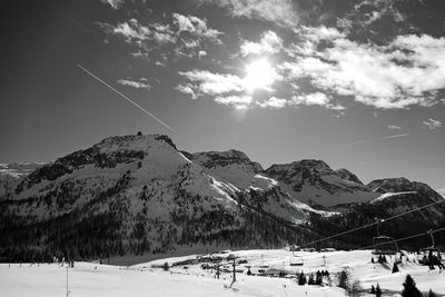 Scenic view of snow covered mountains against sky