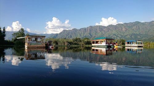 Panoramic view of lake by buildings against sky