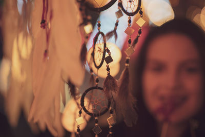 Dreamcatchers hanging against woman at night