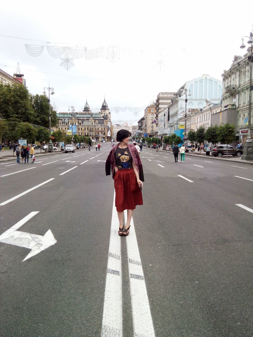 street, road, road marking, transportation, lifestyles, walking, city, rear view, clear sky, building exterior, the way forward, leisure activity, city life, men, car, full length, person, architecture