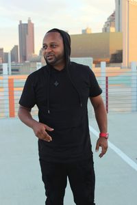 Full length of man standing against sky in city