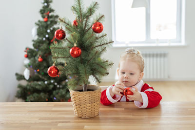 Portrait of cute girl decorating christmas tree