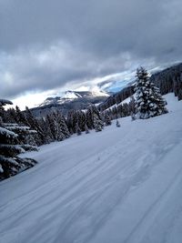 Snow covered landscape against sky