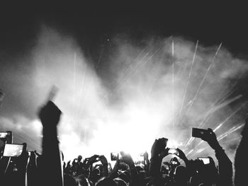 People enjoying music concert at night
