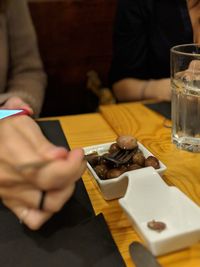 Midsection of man having food in restaurant