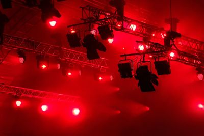 Low angle view of illuminated stage lights
