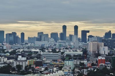 Aerial view of buildings in city against sky during sunset