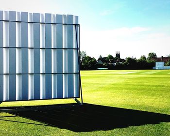 Built structure on field against sky on sunny day