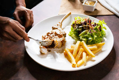 Cropped hand of person having food