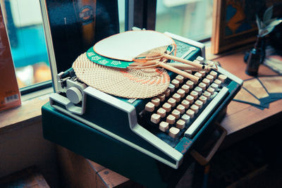 High angle view of hand fans on typewriter