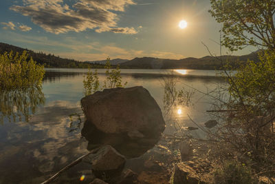 Scenic view of lake against sky during sunset