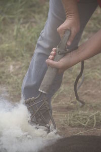 Low section of man holding hands on land