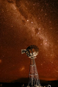 Low angle view of crane against sky at night