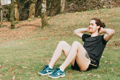 Smiling young man exercising outdoors