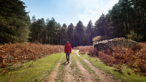 Man with red jacket walking in mountain street