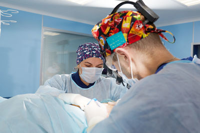 Side view of doctor examining patient in hospital