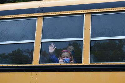 Portrait of boy looking through window