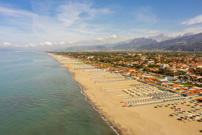 High angle view of townscape by sea against sky