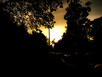 Silhouette trees against sky at sunset