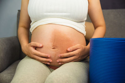 Midsection of woman touching baby