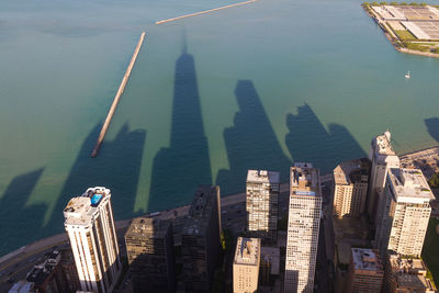 High angle view of skyscrapers in city against sea