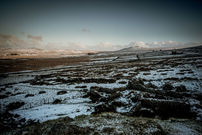 Scenic view of landscape against sky during winter