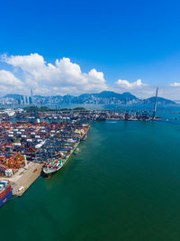 Aerial view of sea and buildings against sky