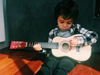 Close-up of girl playing guitar