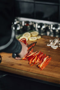 Close-up of chef preparing food on cutting board at restaurant