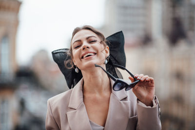 Portrait of a smiling young woman in city