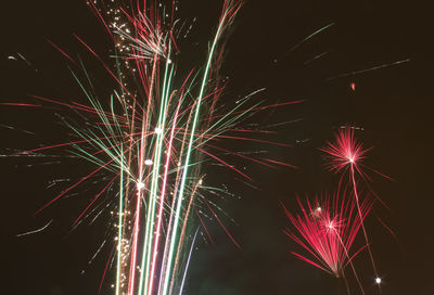 Low angle view of firework display at night