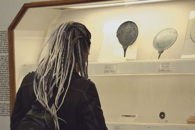 Rear view of woman standing in corridor