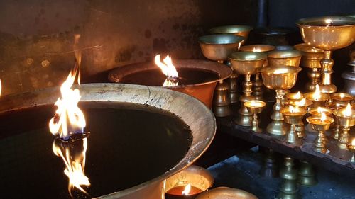 Close-up of lit tea light candles in temple