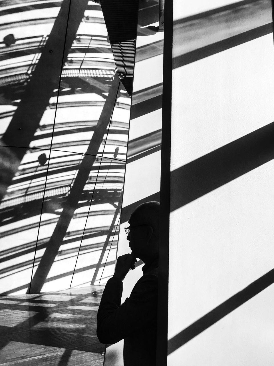 lifestyles, leisure activity, low angle view, men, built structure, architecture, silhouette, standing, railing, person, shadow, unrecognizable person, three quarter length, connection, sunlight, sky, day, bridge - man made structure