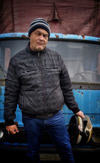 Full length of man standing against car