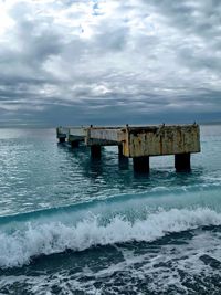 Lifeguard hut in sea against sky