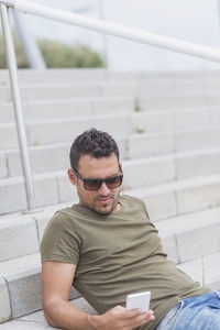 Portrait of young man sitting on steps