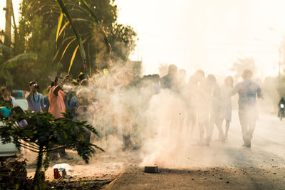 Group of people on street in city during traditional festival