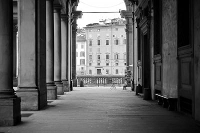 Empty alley amidst buildings in city