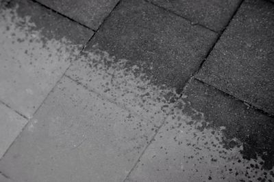 High angle view of puddle on sidewalk