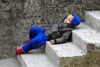 Portrait of boy sitting on rock