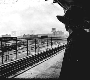 Rear view of woman standing on railroad station platform