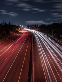 High angle view of light trails on highway at night