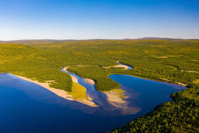 Aerial view of pulmankijärvi lake and sand banks surrounded by forest in nuorgam, finnish lapland