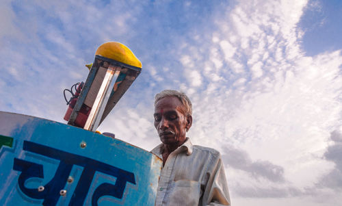 Low angle view of vendor against sky