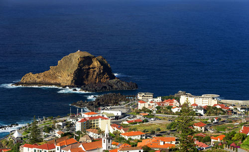 Built structures against calm blue sea