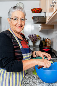 Portrait of smiling woman standing at home