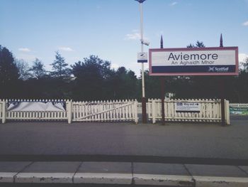 Information sign against sky