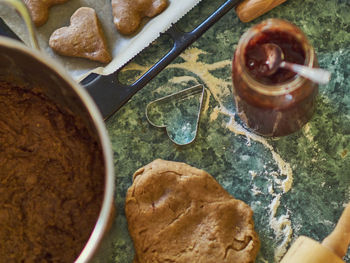 High angle view of jam by dough on table in kitchen