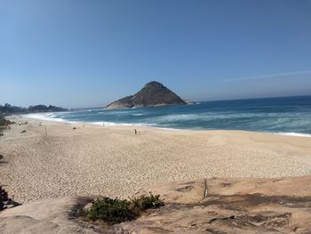 Scenic view of beach against clear sky